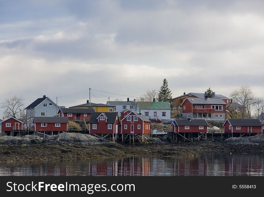 Red houses on stilts at the sea