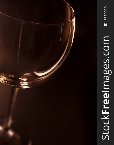 Wine glass with dark background and golden hue. Wine glass with dark background and golden hue.