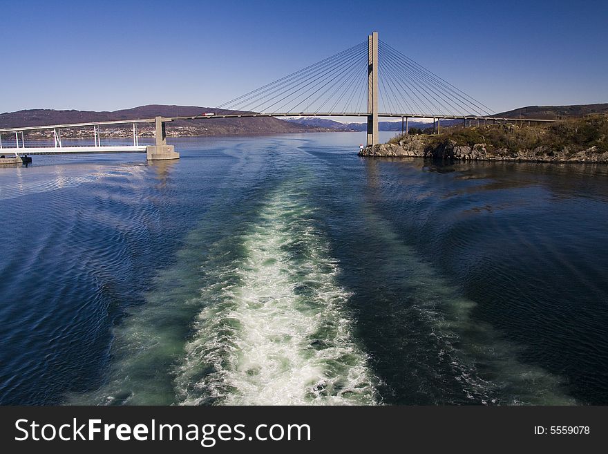 Ship drives through under a bridge. Ship drives through under a bridge