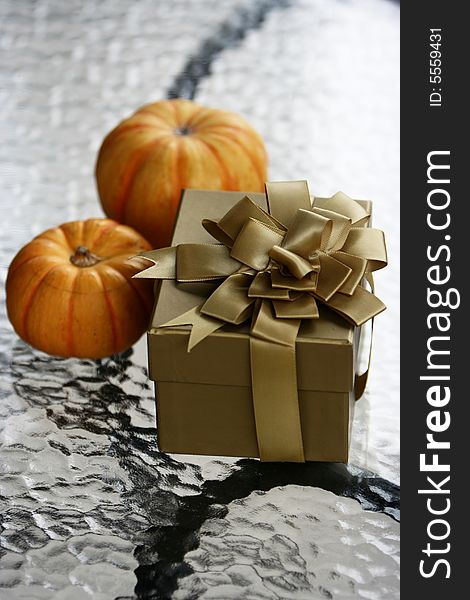 A brown gift box wiht 2 orange squash