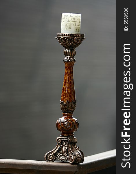 Antique wooden candlestick isolated on grey background