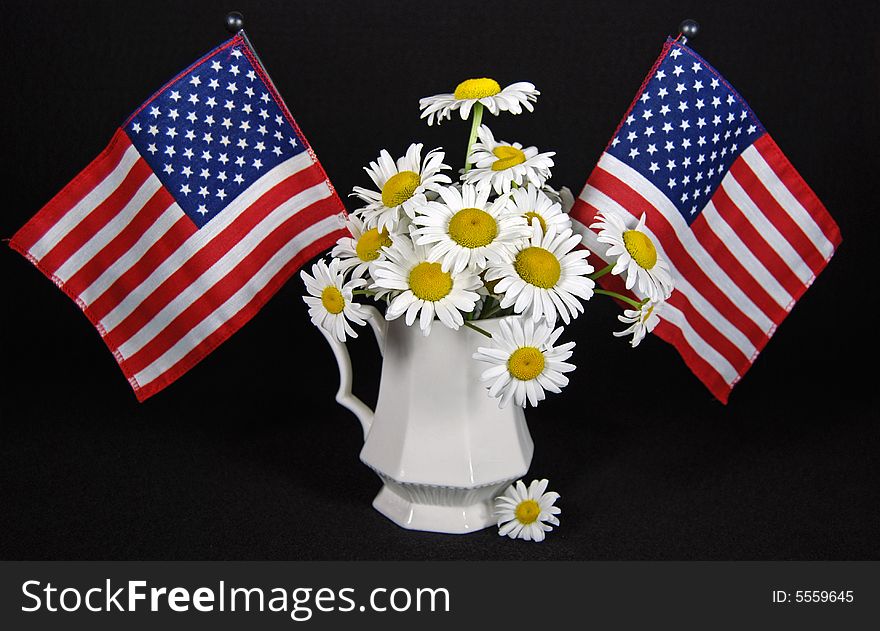 Pair of American flags in a daisy bouquet. Pair of American flags in a daisy bouquet.