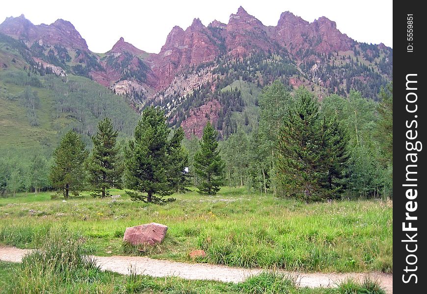 Path next to jagged Rocky Mountain peaks. Path next to jagged Rocky Mountain peaks.