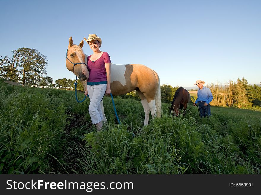 Female Farmer Smiling With Horse - Horizontal