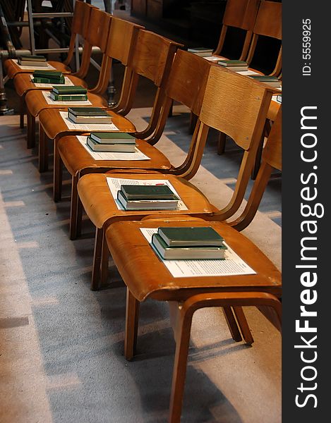 Row of chairs with bible on it in a cathedral. Row of chairs with bible on it in a cathedral