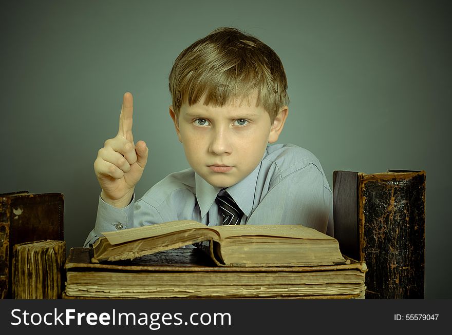 The boy spends time reading old books