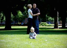 Baby Laughing While Parents Hug - Horizontal Stock Photography