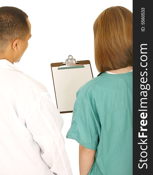 Two medical staff looking at clip board. camera angle from the back. isolated on white. Two medical staff looking at clip board. camera angle from the back. isolated on white