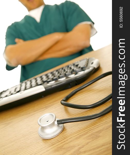 Close up of stethoscope sit on nurse or doctor's table. there is man in medical uniform on the background. Close up of stethoscope sit on nurse or doctor's table. there is man in medical uniform on the background