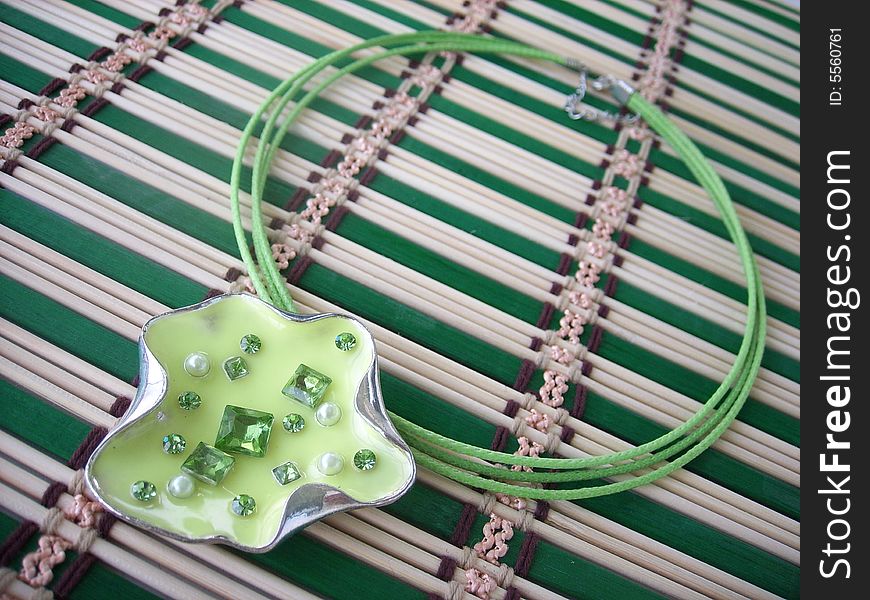 Beautiful green coulomb-leaf with beads