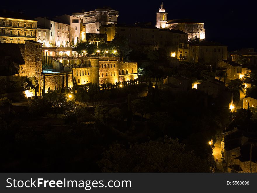 Night view of the illuminated hilltop town of Gordes in Provence, France. Night view of the illuminated hilltop town of Gordes in Provence, France.