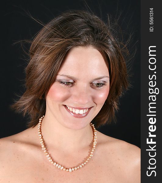 Beautiful young woman with bare shoulders and pearls. Beautiful young woman with bare shoulders and pearls