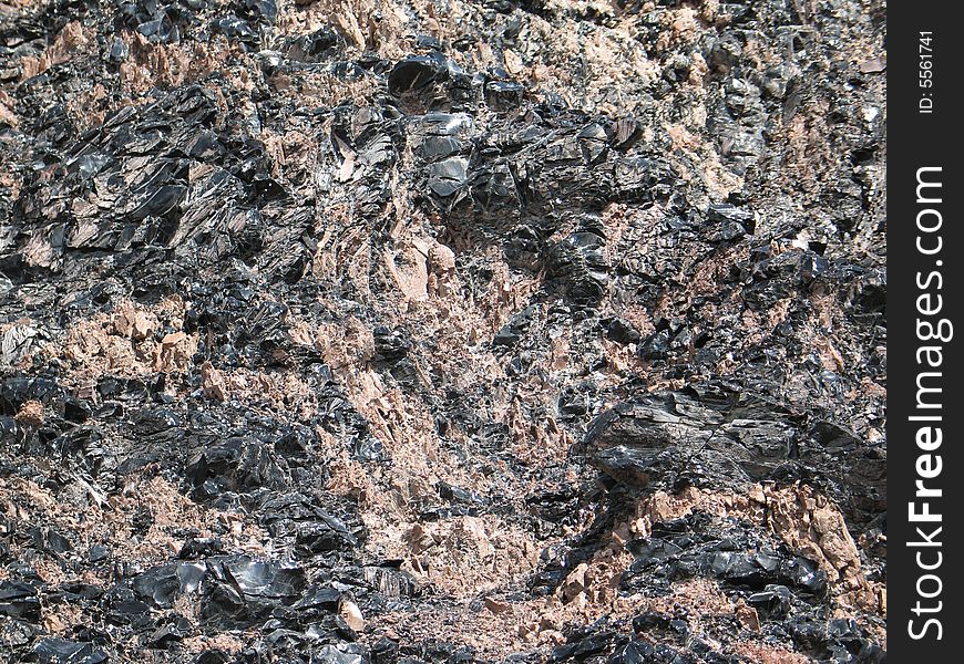 Obsidian mixed with other concretes, natural texture background. Obsidian mixed with other concretes, natural texture background