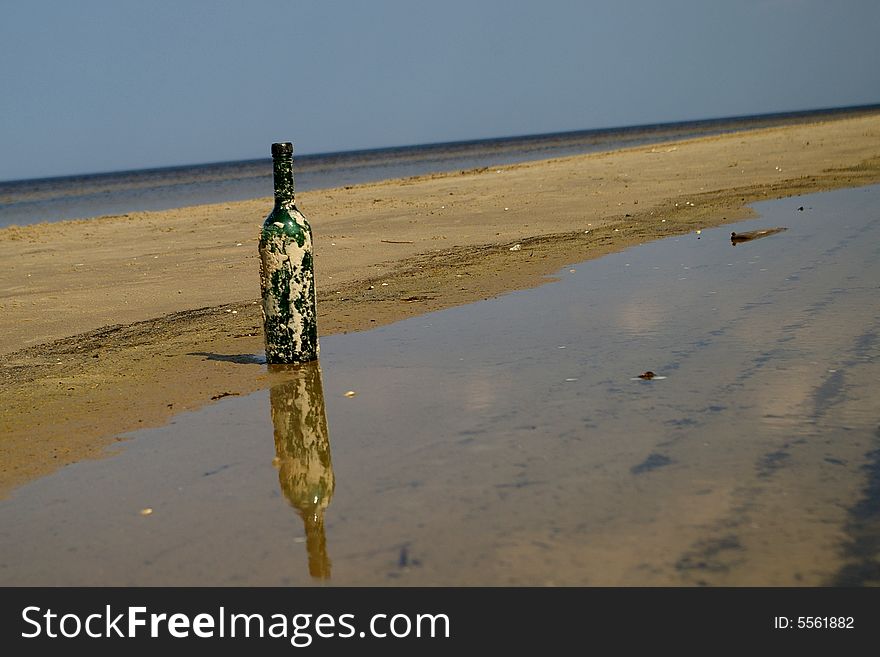 Old wine bottle was standing on the coast of Riga gulf and waiting for someone. Old wine bottle was standing on the coast of Riga gulf and waiting for someone