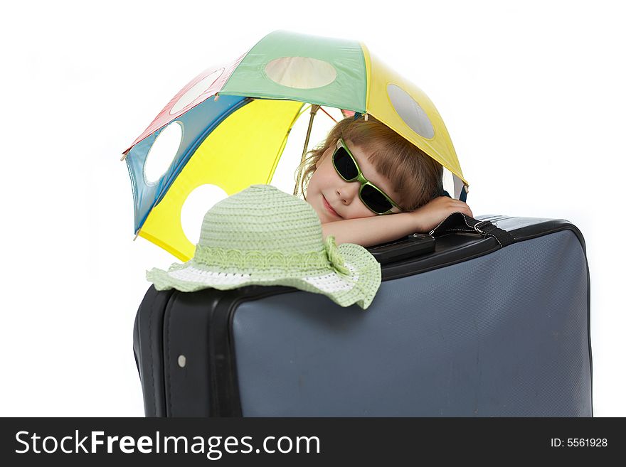 Nice  girl with umbrella on a valise. Nice  girl with umbrella on a valise