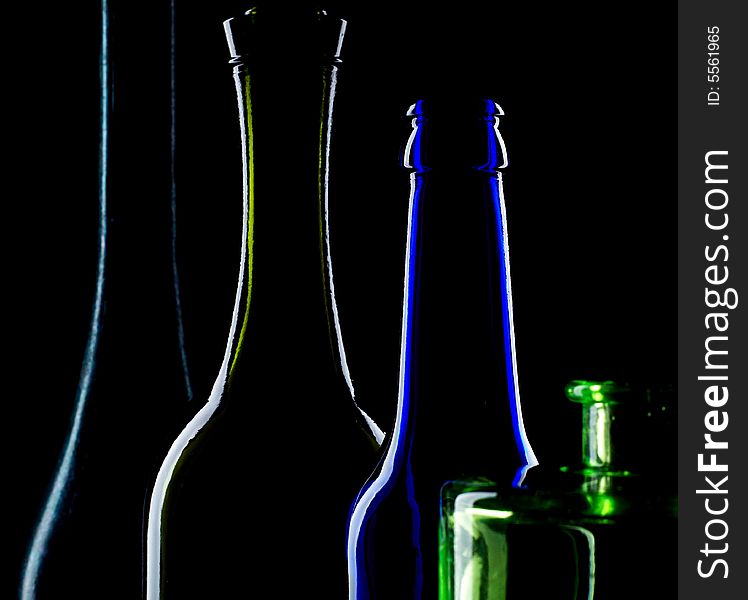 An image of necks of bottles on black background