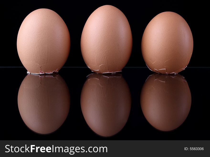 Three eggs on black background
