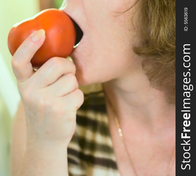 Woman eating tomato for your design