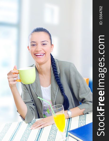 Young businesswoman having coffee break