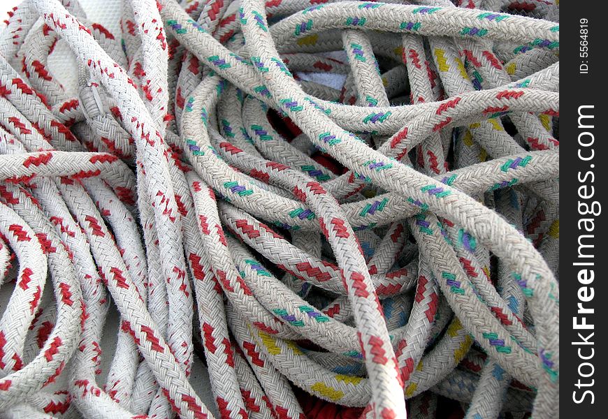 Red, blue and white ropes in a tangled mess.