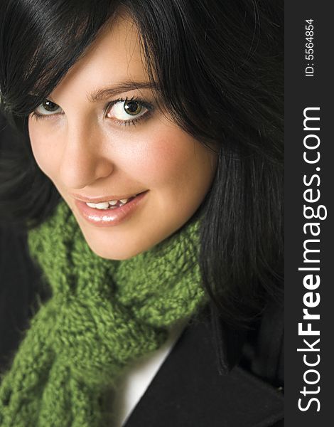 Dark haired young woman wearing a green scarf and black blazer. Dark haired young woman wearing a green scarf and black blazer