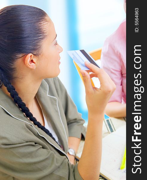 Two young businesswomen reading message on coffee break, outdoors. Two young businesswomen reading message on coffee break, outdoors