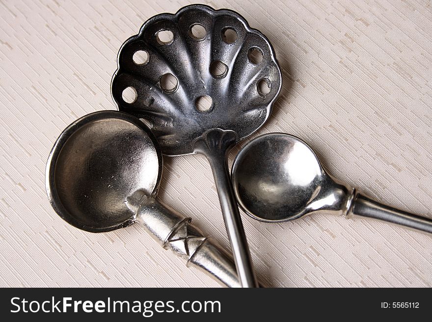 Silver spoons on a cream coloured box background. Silver spoons on a cream coloured box background