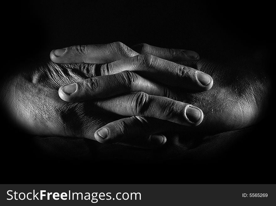 Close-up hands of the man over black