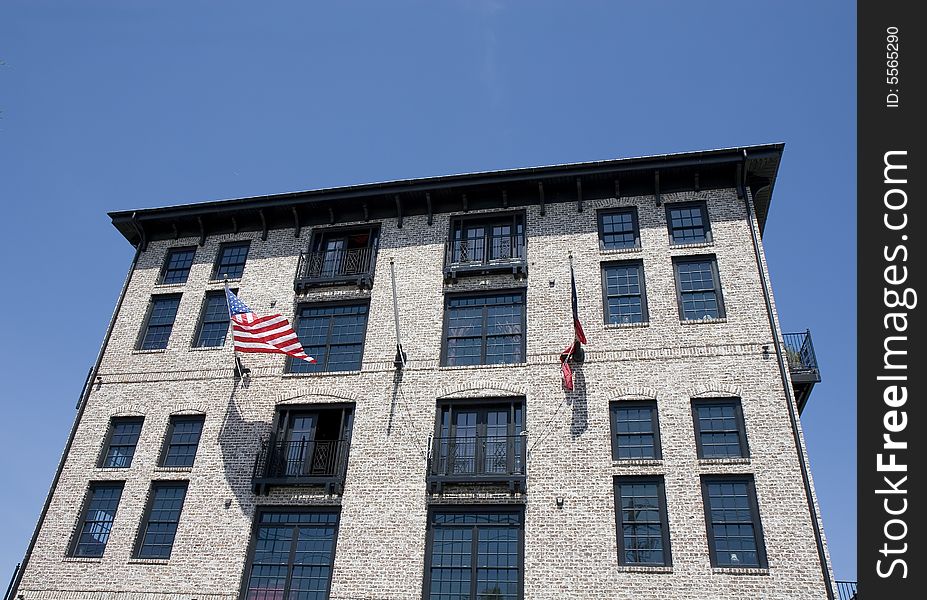 Modern loft building in a classic architecture style with american flags out front. Modern loft building in a classic architecture style with american flags out front