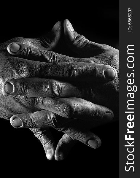 Close-up hands of the man over black