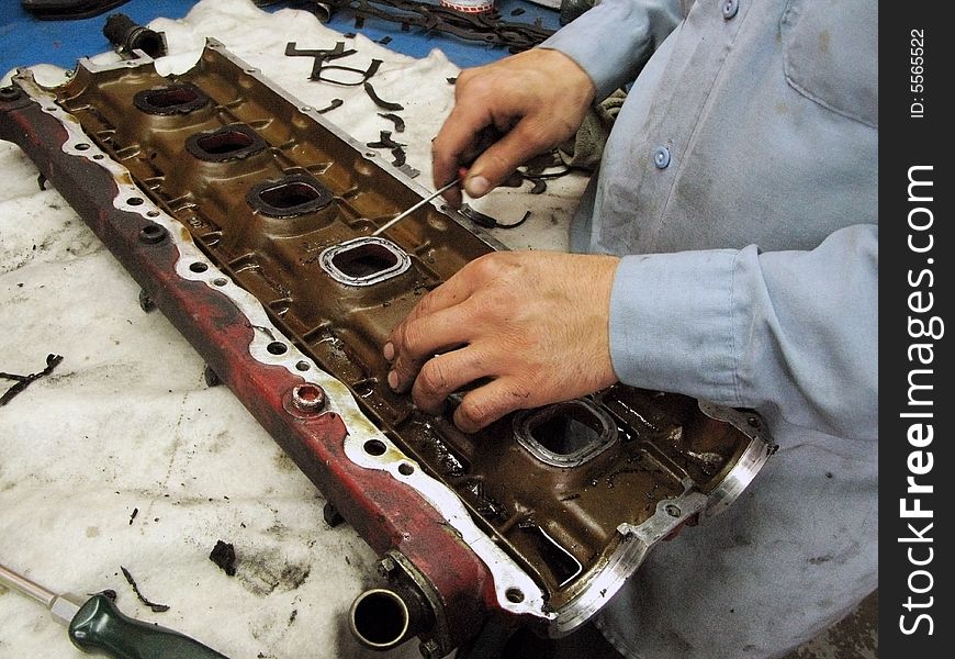 Close-up of automechanic's hands placing new seals