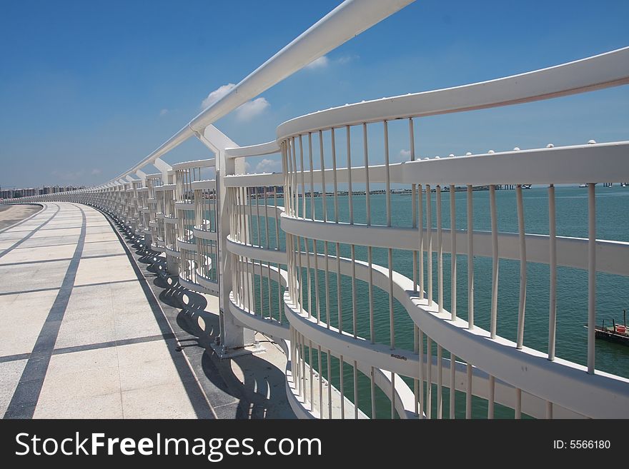 White railing of a new arcing bridge. White railing of a new arcing bridge