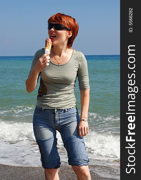 Young beautiful woman has a rest on coast of ocean