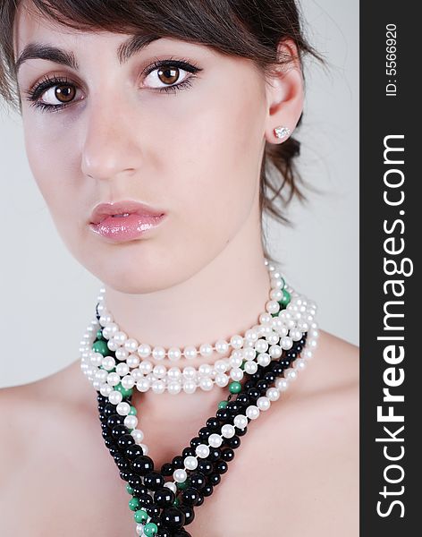 Portrait of beautiful girl with varicoloured beads on a neck. Portrait of beautiful girl with varicoloured beads on a neck