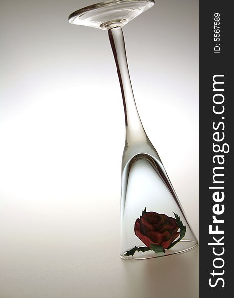 Single clear glass with red rose inside. Single clear glass with red rose inside