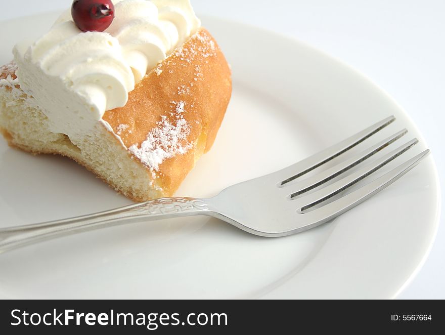 Cream cake and wilver fork on white plate. Cream cake and wilver fork on white plate