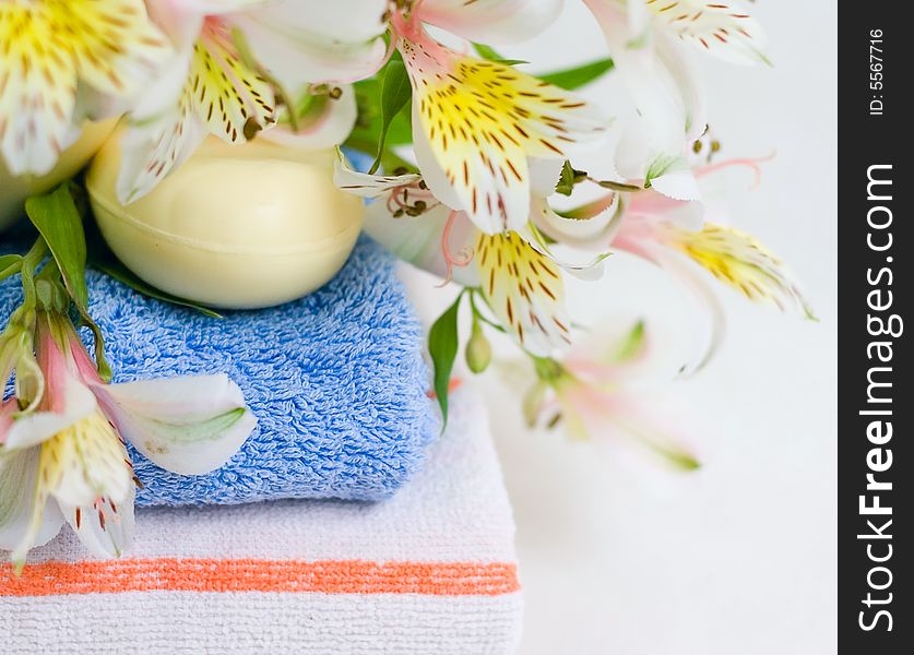 Soap and flower on blue fabric background