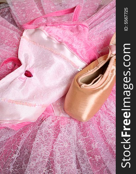 Pink Ballet costume and a used ballet shoe