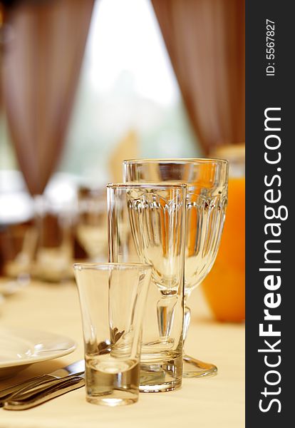 Glassware on Banquet Table in Restaurant. Focus on Glass. Glassware on Banquet Table in Restaurant. Focus on Glass