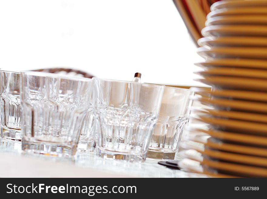 Glass and Plates on Glass Table for Serving. Focus on Rocks Glass