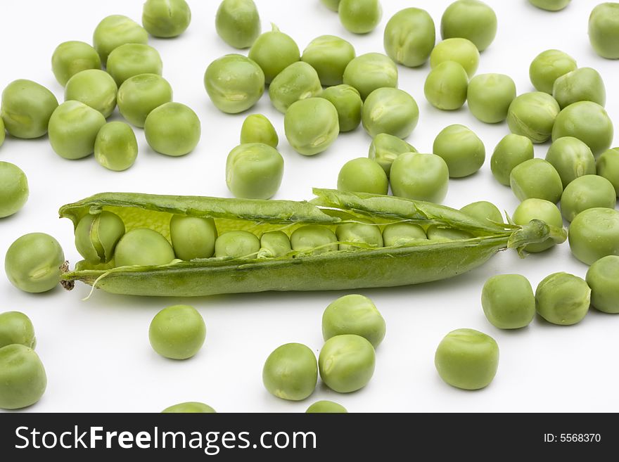 Fresh green peas on a white background