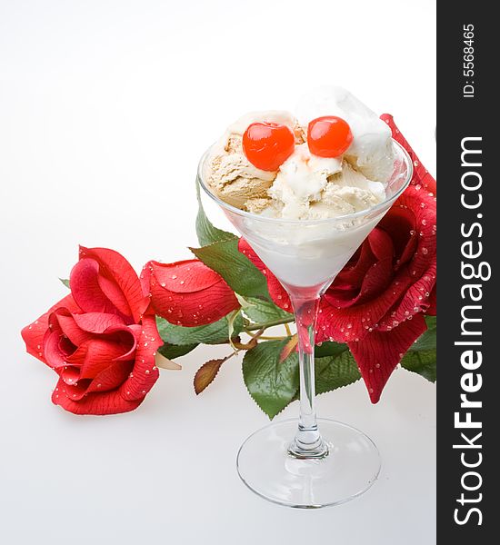 Ice-cream with a cherry in a glass on a white background. Ice-cream with a cherry in a glass on a white background.