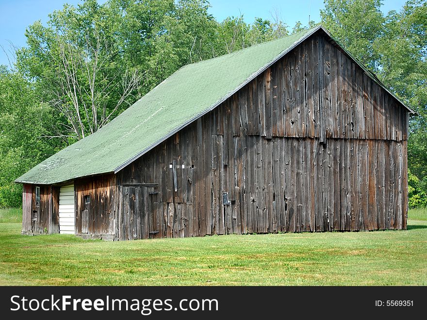 Old dilapidated barn in summer. Old dilapidated barn in summer.