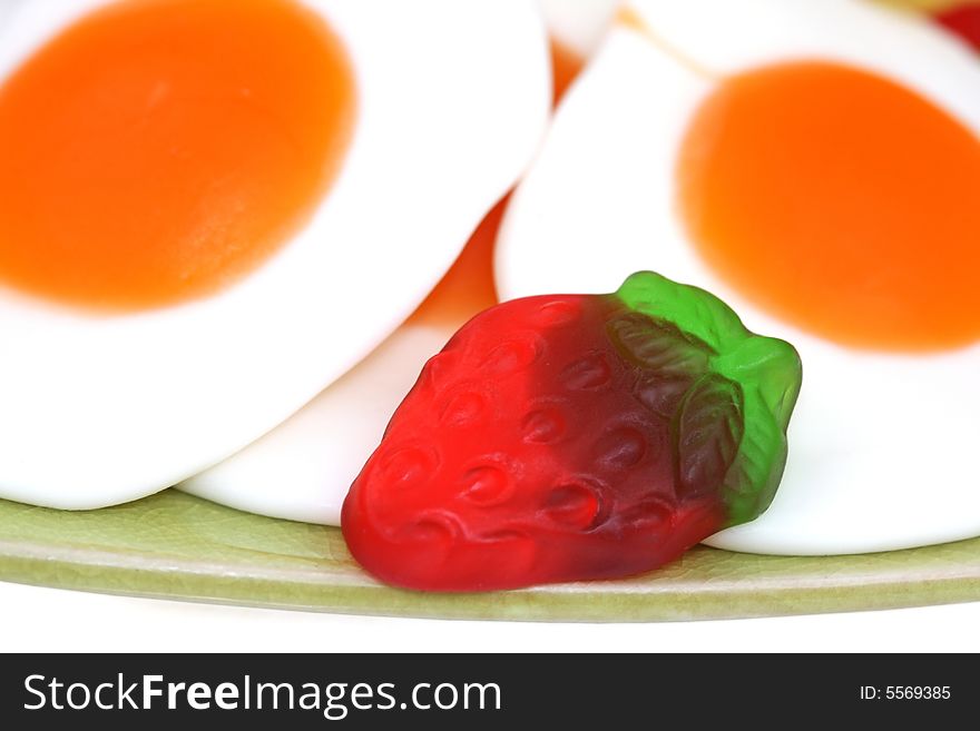 Gummi fryed eggs  and strawberry close up. Gummi fryed eggs  and strawberry close up