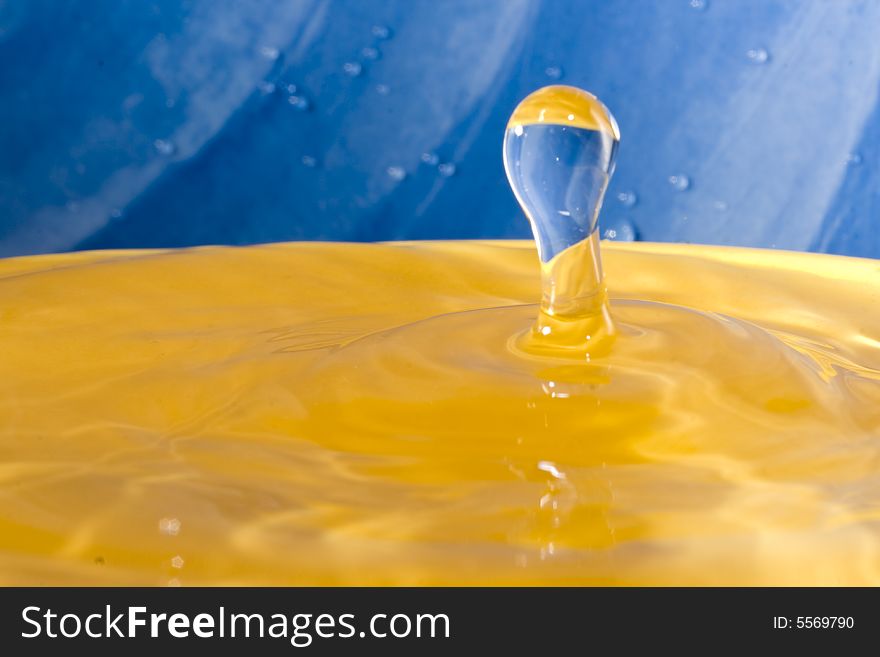 Drop of water on a vibrant background frozen in time. Drop of water on a vibrant background frozen in time