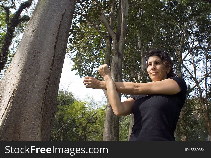 Woman in Park Stretching Her Arms - Horizonta