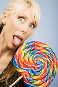 Woman Licking A Lollipop Royalty Free Stock Photography