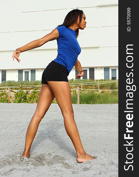 Woman exercising on the beach and performing a stretch. Woman exercising on the beach and performing a stretch.