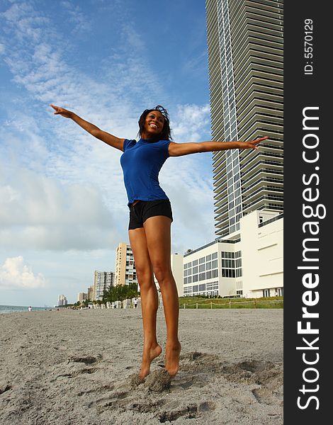 Young woman jumping at the beach.