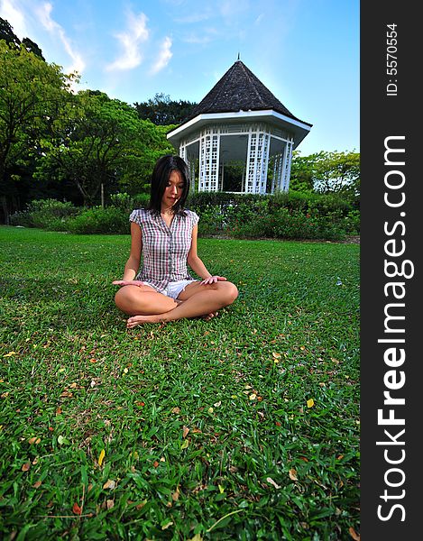 Girl doing Yoga/ mediating in a peaceful park